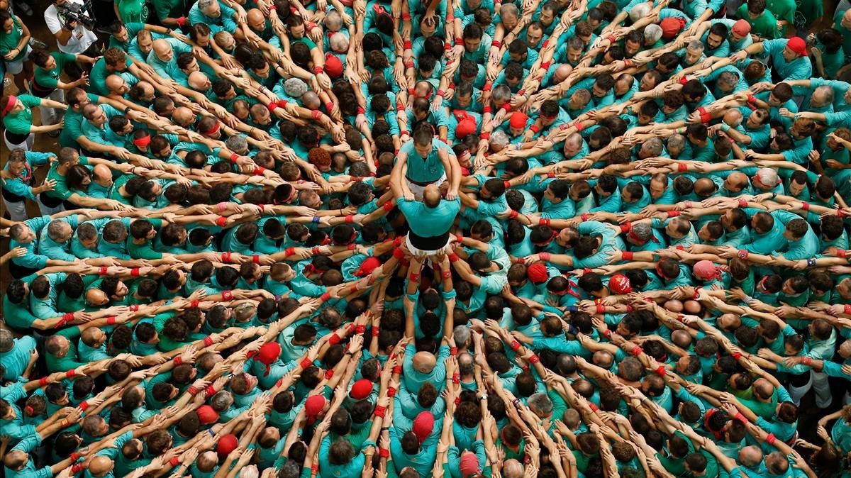 Castellers de Vilafranca start to form a human tower called castell during a biannual competition in Tarragona city.